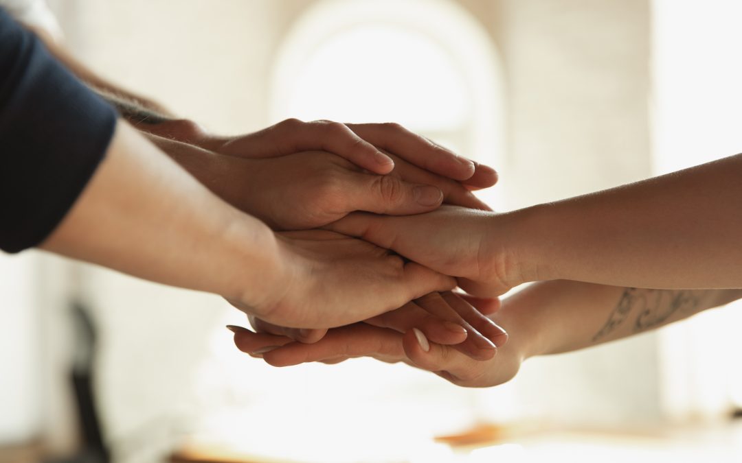 close up of caucasian male and female hands covering one another shaking concept of business finance job copyspace